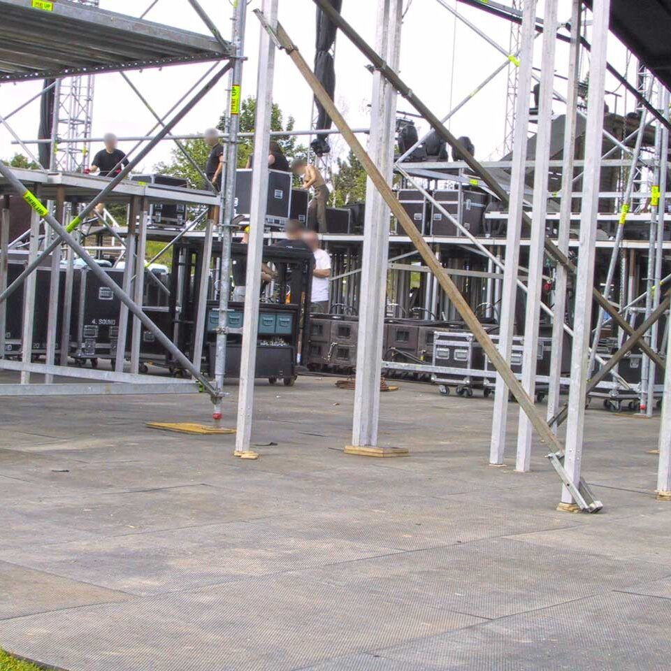 Bodenmatte zum Rasenschutz als Fläche verlegt unter Bühnengerüst bei Open-Air-Event