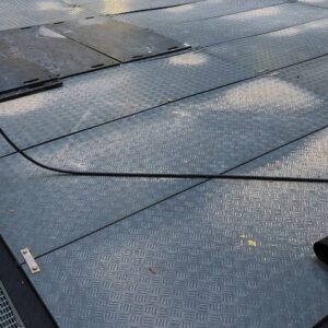 Bodenschutzplatten mit verlegten Kabeln sorgen für sichere Arbeitsbereiche auf Baustellen und Events.