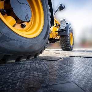 Ein Bagger fährt auf Kunststoff-Fahrplatte