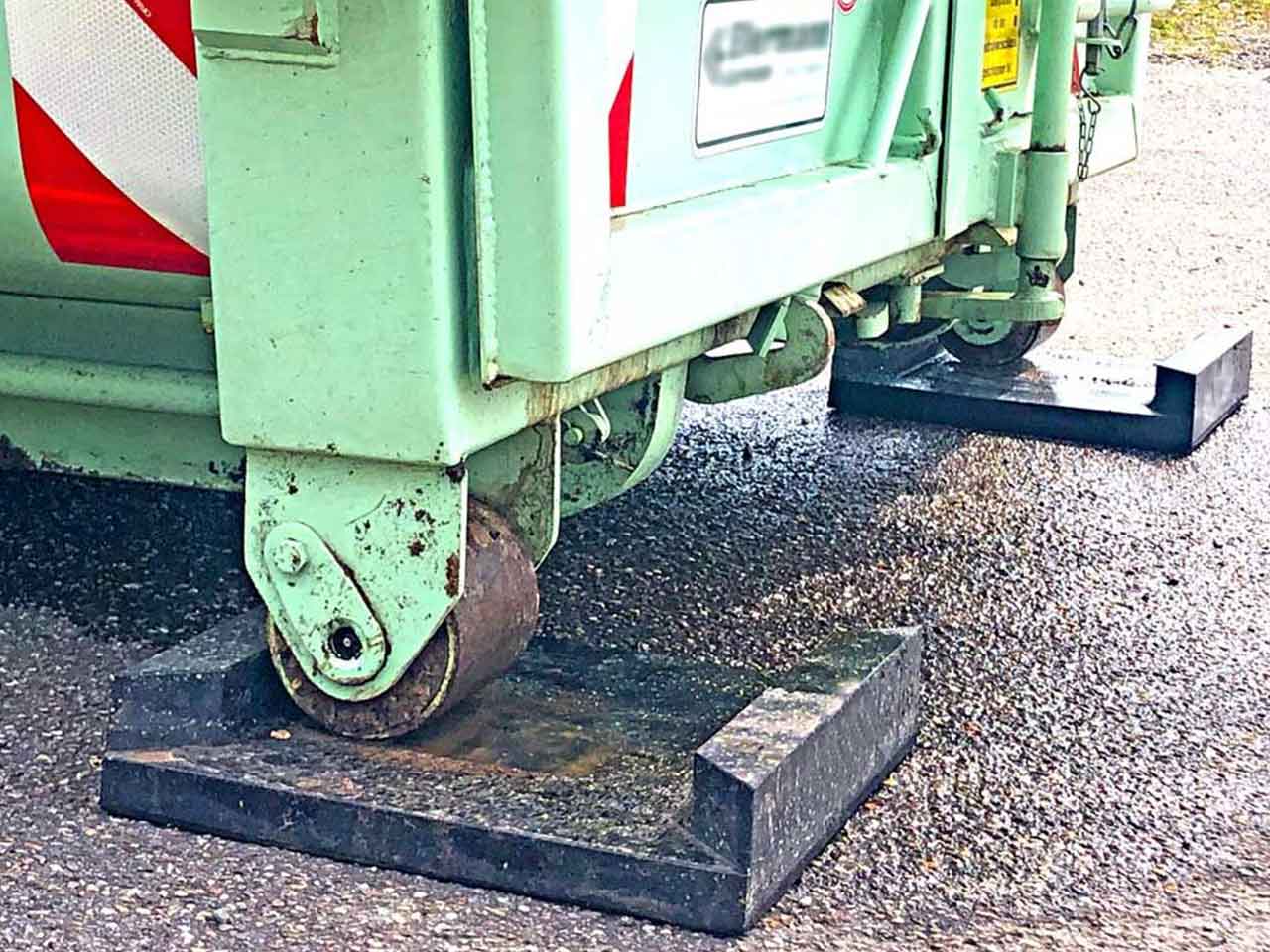 Container auf Abrollcontainer-Bodenschutzplatte